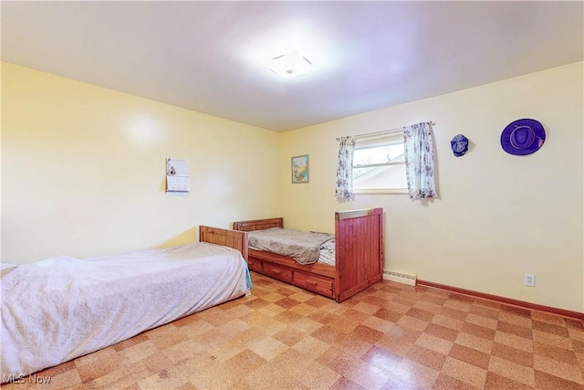 bedroom featuring light floors and baseboards