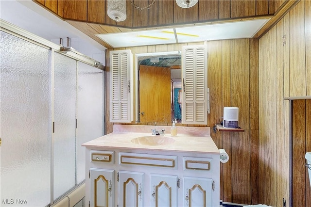 full bath with vanity and a shower with shower door