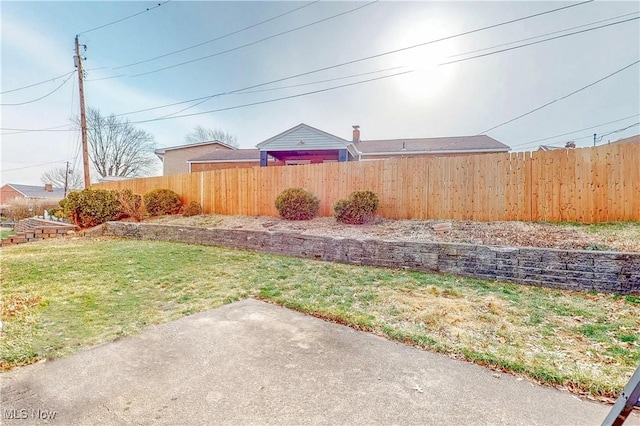 view of yard with fence and a patio