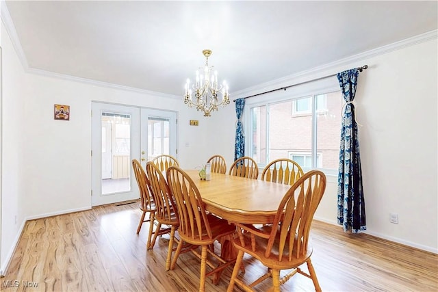 dining room with baseboards, french doors, light wood-style floors, and crown molding