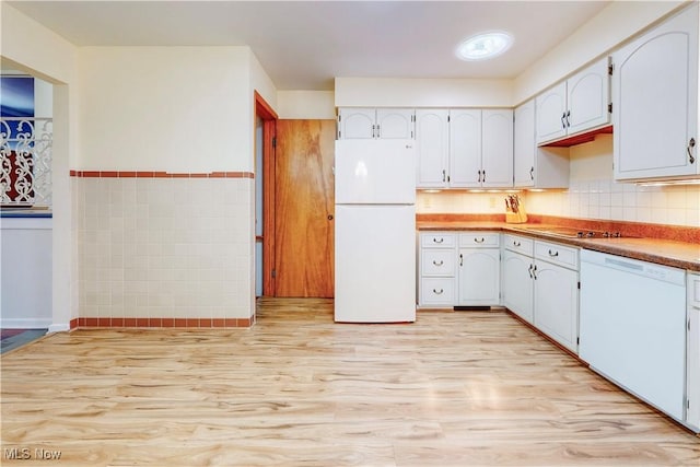 kitchen with light wood-style floors, white appliances, white cabinets, and tile walls