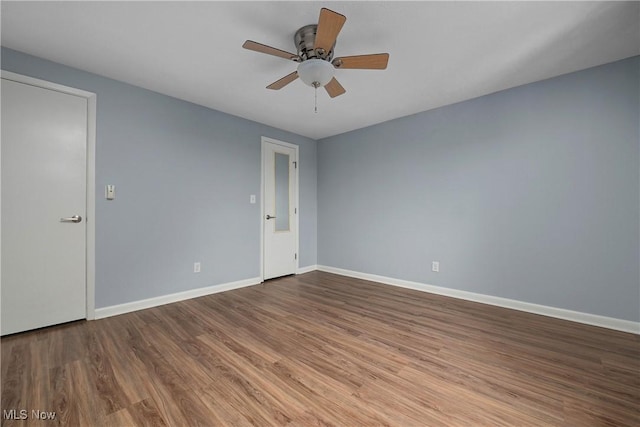 unfurnished room featuring ceiling fan, baseboards, and wood finished floors