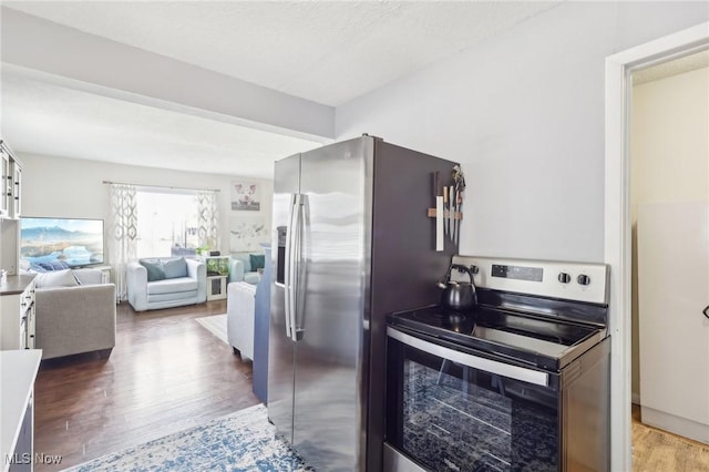 kitchen with stainless steel appliances, wood finished floors, and open floor plan