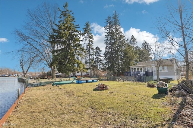 view of yard featuring a water view and fence