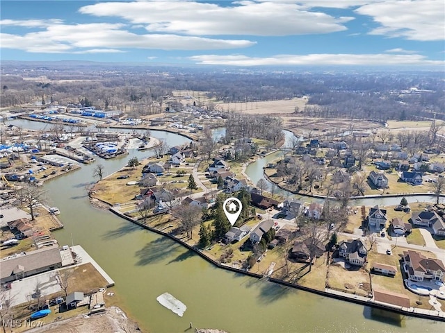 drone / aerial view featuring a residential view and a water view