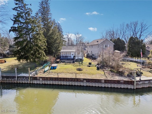 exterior space with a deck with water view and a yard