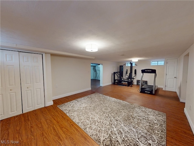 workout area featuring baseboards and wood finished floors