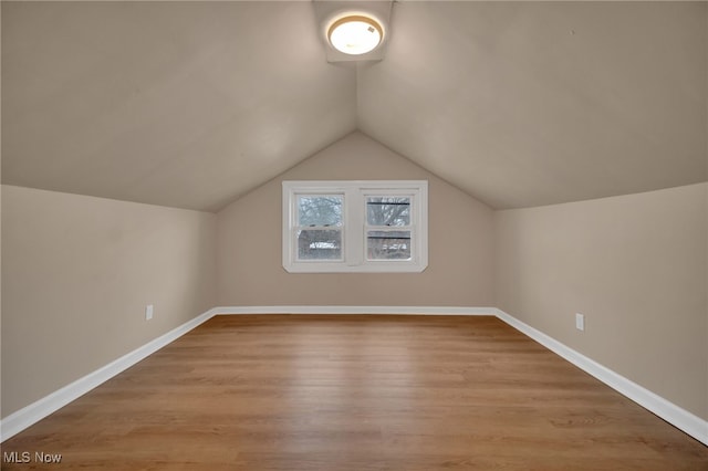 additional living space featuring light wood-style flooring and baseboards