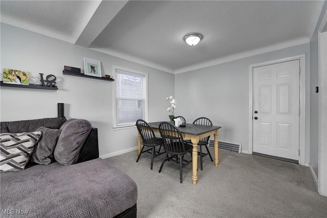 dining room featuring carpet floors, baseboards, and visible vents