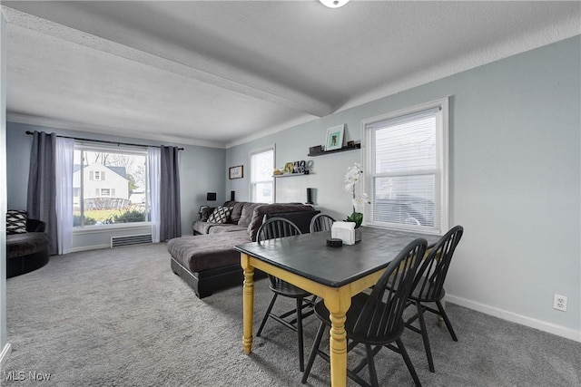 dining area featuring carpet, visible vents, a textured ceiling, and baseboards