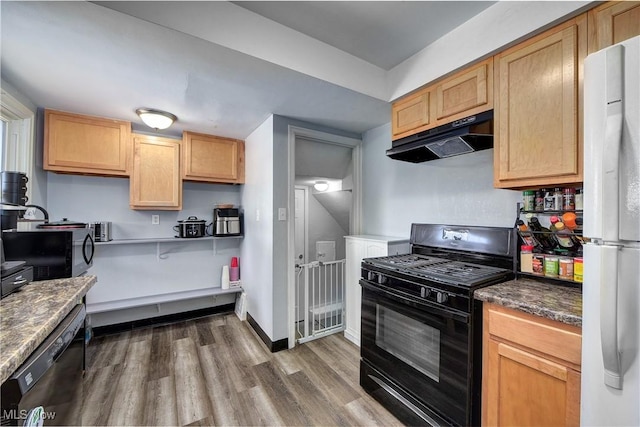 kitchen with dishwasher, dark wood-style flooring, freestanding refrigerator, black range with gas stovetop, and under cabinet range hood