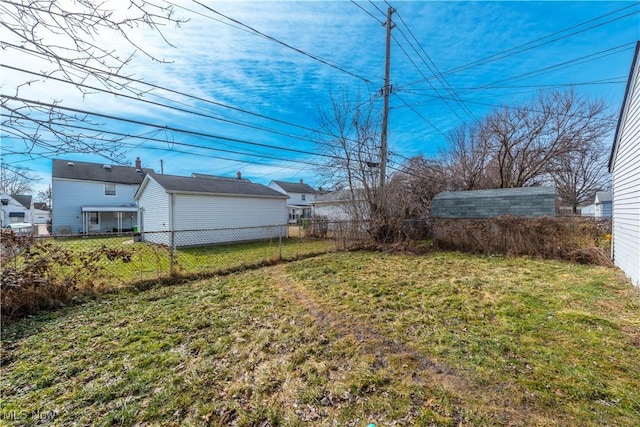 view of yard featuring an outbuilding and fence