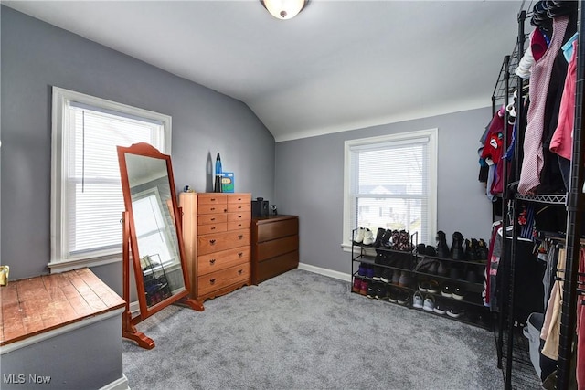 bedroom with lofted ceiling, carpet flooring, and baseboards