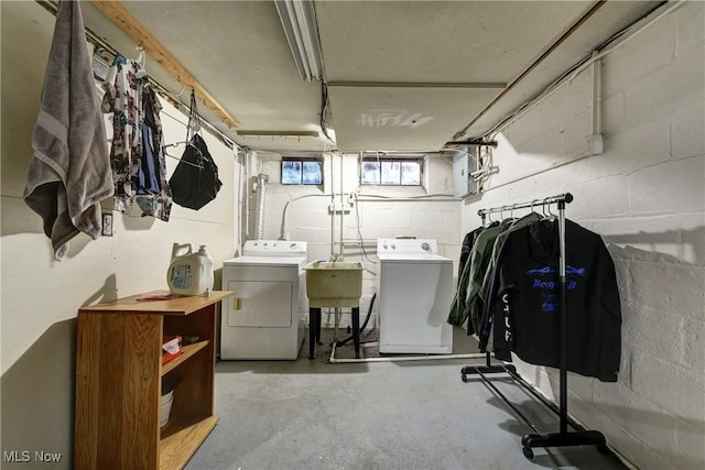 below grade area featuring separate washer and dryer and a sink