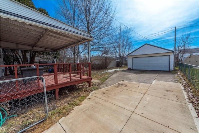 view of yard with a garage, a deck, an outdoor structure, and fence