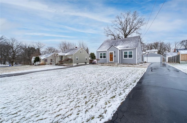 bungalow with a detached garage and an outbuilding