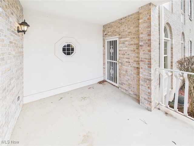 view of exterior entry with brick siding