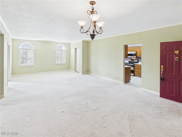 unfurnished room featuring baseboards, crown molding, a notable chandelier, and light colored carpet