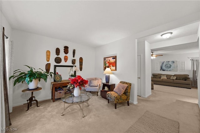 living area featuring carpet flooring and baseboards