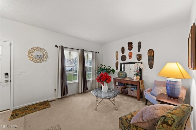 living room featuring baseboards and light colored carpet