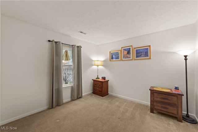 interior space with baseboards and visible vents