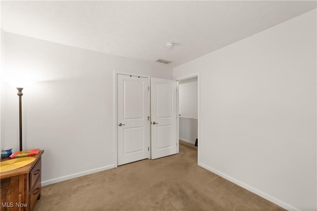 bedroom featuring light colored carpet, visible vents, and baseboards