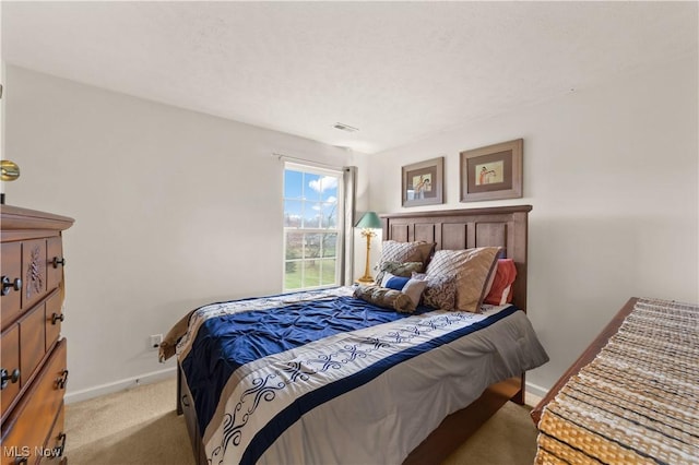 bedroom featuring light carpet, visible vents, and baseboards