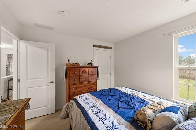 bedroom with light carpet and visible vents