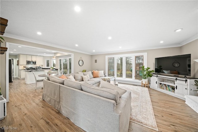 living area featuring ornamental molding, light wood-type flooring, and recessed lighting