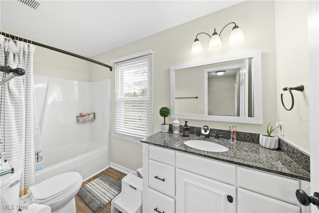 full bathroom with toilet, wood finished floors, visible vents, vanity, and shower / bath combination with curtain