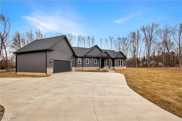 view of front of house with an attached garage, driveway, a front lawn, and a shingled roof