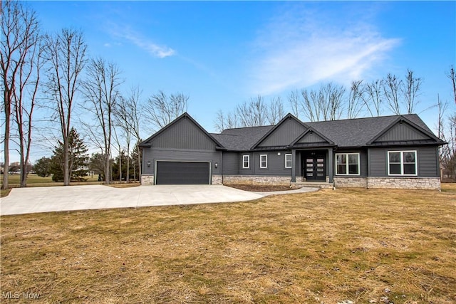 view of front of house with a garage, roof with shingles, concrete driveway, and a front yard