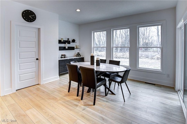 dining area featuring a healthy amount of sunlight, light wood-style floors, visible vents, and recessed lighting