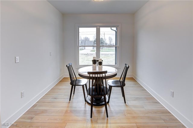 dining room with light wood-style floors and baseboards