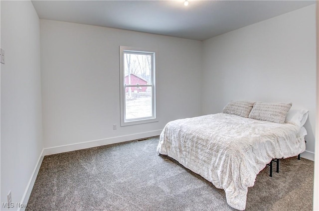 bedroom featuring carpet and baseboards