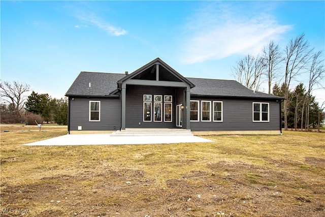 back of house with a patio area and a lawn