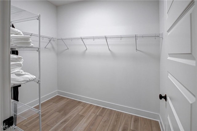 spacious closet with wood finished floors