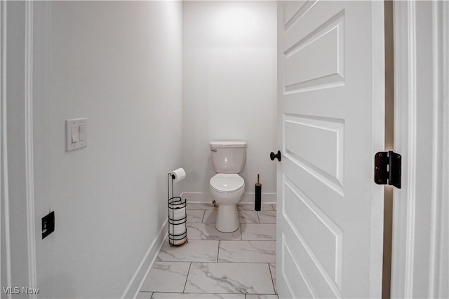 bathroom with marble finish floor, toilet, and baseboards