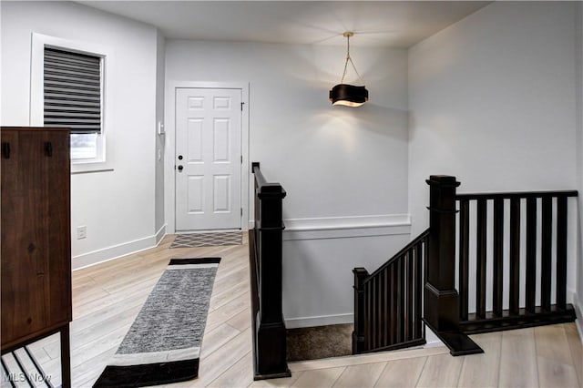 entryway with wood finished floors and baseboards