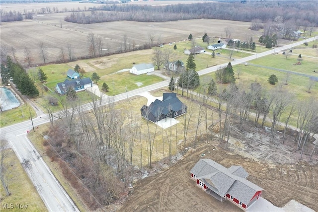 birds eye view of property with a rural view