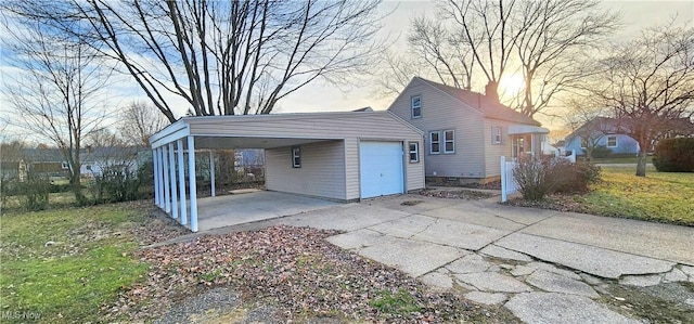 garage with a carport and driveway