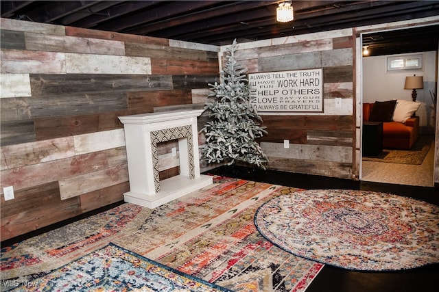 interior space featuring a tile fireplace and wooden walls