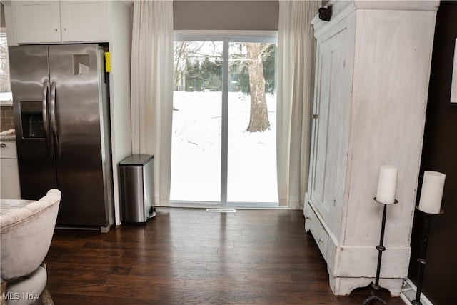 kitchen featuring dark wood-type flooring, white cabinets, and stainless steel fridge