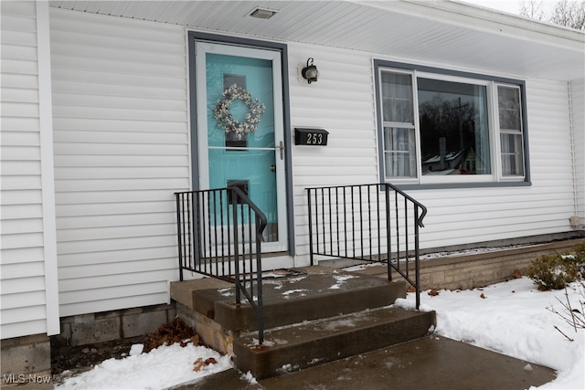 view of snow covered property entrance