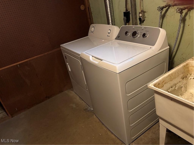 laundry area featuring laundry area, separate washer and dryer, and a sink