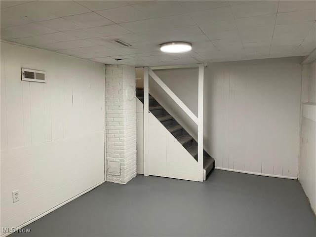 finished basement featuring stairway and visible vents