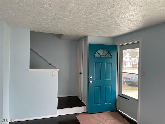 foyer with a textured ceiling