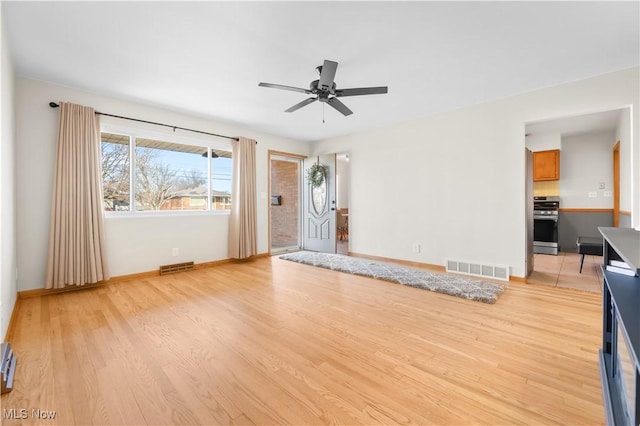 unfurnished living room featuring light wood-style floors, visible vents, and ceiling fan