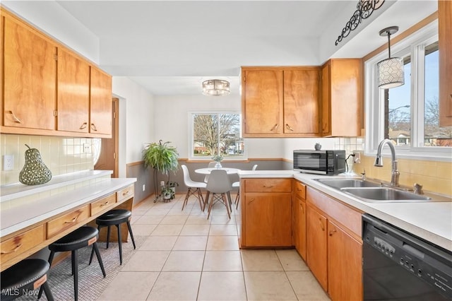 kitchen featuring a sink, dishwasher, light tile patterned floors, and light countertops