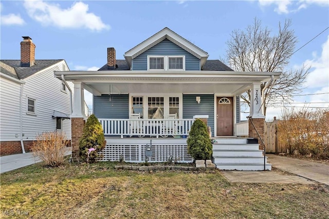 view of front of home with covered porch and a shingled roof